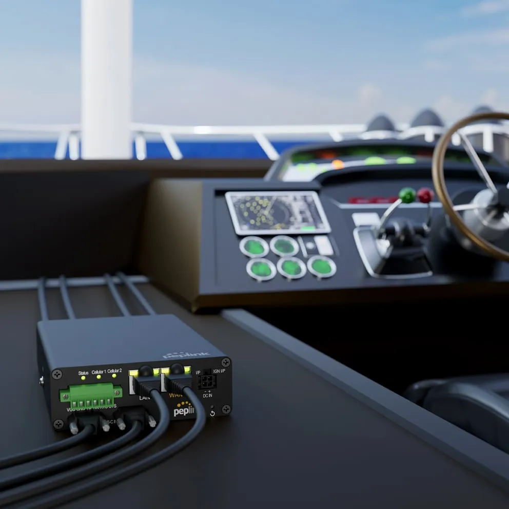 Peplink TA Cloud Appliance on a boat dashboard with connected power and Ethernet cables for marine networking.