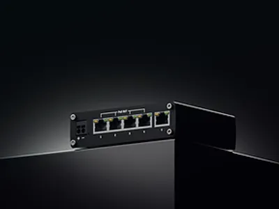 Промышленный неуправляемый PoE-коммутатор Teltonika TSW101 с 5 гигабитными портами на глянцевой поверхности на тёмном фоне. Промышленный неуправляемый PoE-коммутатор Teltonika TSW101 с 5 гигабитными портами на глянцевой поверхности на тёмном фоне.