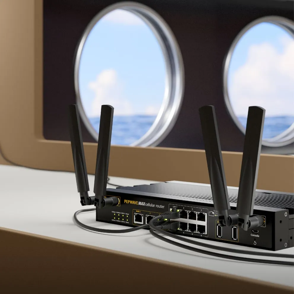 Pepwave MAX cellular router with four antennas and connected Ethernet cables on a white surface near porthole windows