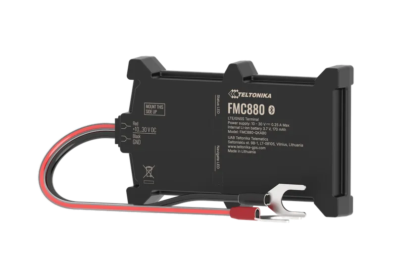 Teltonika FMC880 LTE GPS-трекер для транспорта с подключённым кабелем и инструкцией по установке сверху.
