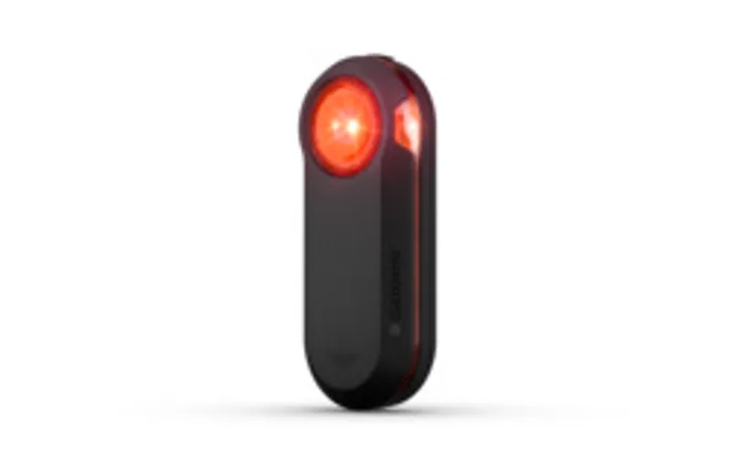 Garmin Varia RTL 516 radar rear light with illuminated red lens and side ventilation slits mounted on a bike.