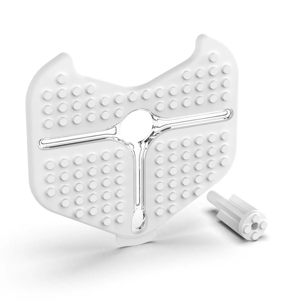 iRobot Root Brick Top Accessory, a white shield-shaped plastic plate with raised circular studs and a central metallic iRobot Root Brick Top Accessory, a white shield-shaped plastic plate with raised circular studs and a central metallic