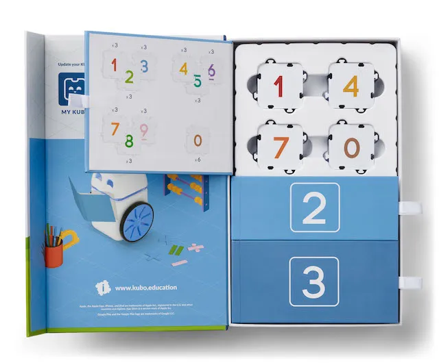 KUBO Coding Math Set open box with blue instruction booklet, number tiles 0-9 in white and blue puzzle pieces, and KUBO Coding Math Set open box with blue instruction booklet, number tiles 0-9 in white and blue puzzle pieces, and