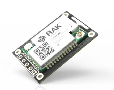 RAK11310 WisBlock Core module featuring a green PCB with black headers, white top shield, antenna connector, and mounting RAK11310 WisBlock Core module featuring a green PCB with black headers, white top shield, antenna connector, and mounting