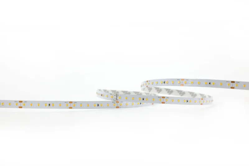 Synergy 21 LED Flex Strip 2022 coiled on white background with yellow LED chips and copper contact pads for DC24V lighting.