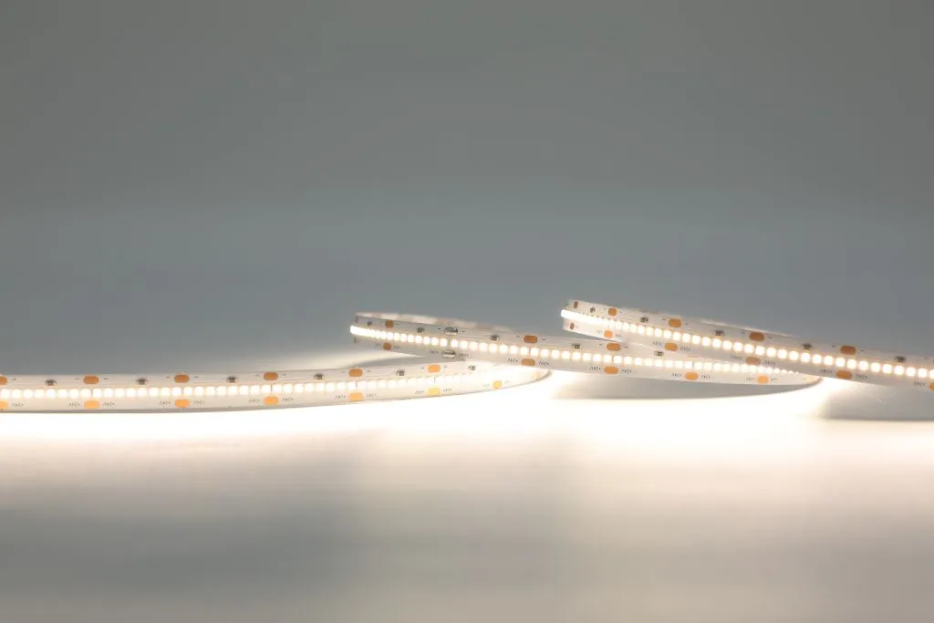 Synergy 21 LED Flex Strip 2022 emitting warm white light from coiled SMD LEDs on a grey surface for indoor lighting. Synergy 21 LED Flex Strip 2022 emitting warm white light from coiled SMD LEDs on a grey surface for indoor lighting.