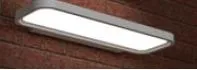 Synergy 21 LED office line Wand-Panel grau, dimmbar, grey linear LED fixture with white illuminated panel mounted on red Synergy 21 LED office line Wand-Panel grau, dimmbar, grey linear LED fixture with white illuminated panel mounted on red
